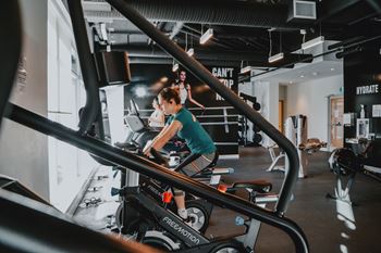 A person is working out on a stationary bike in a gym.